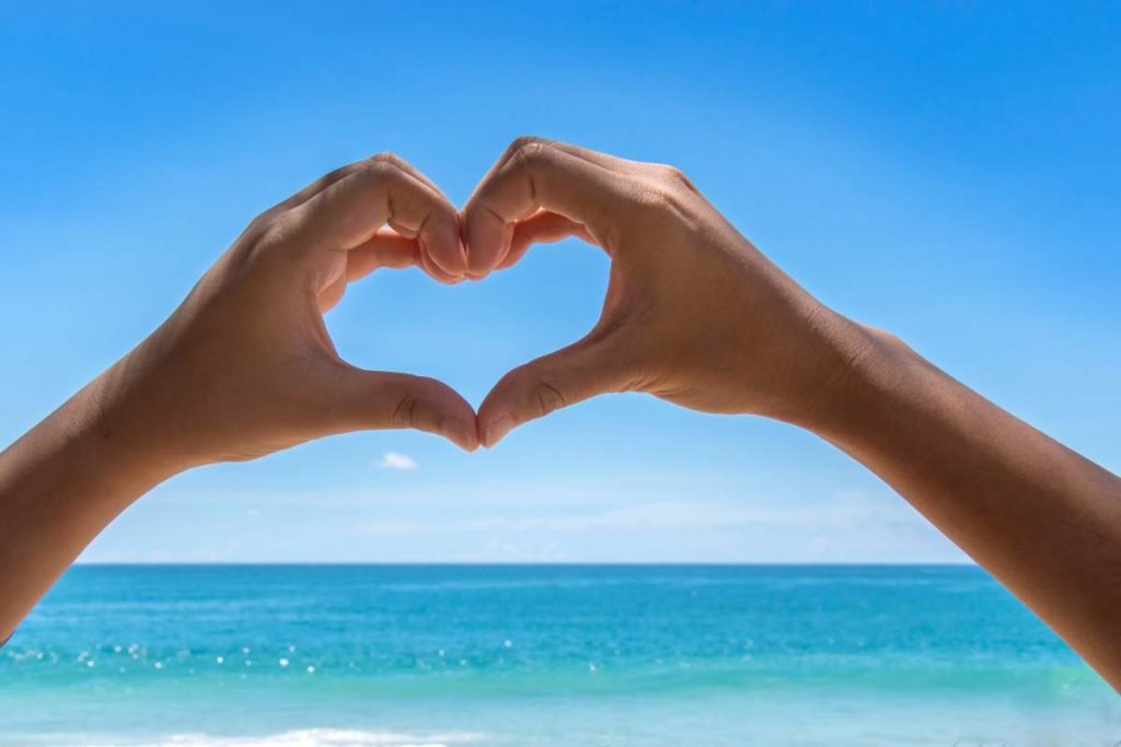 Heart shaped hand sign for the sea