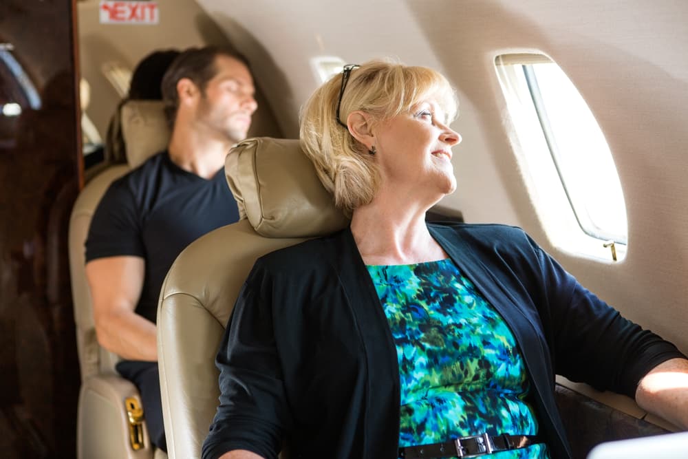 When you can fly after having DVT: Middle age woman looking out of plane window