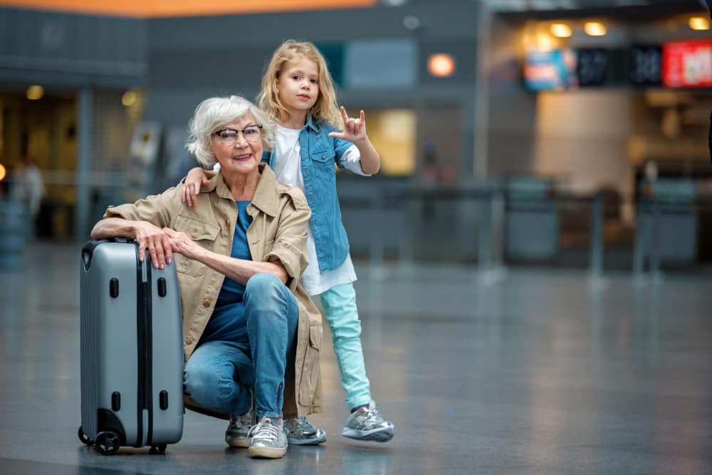 How Long After Hip Replacement Can I Fly? Grandmother at the airport with her granddaughter