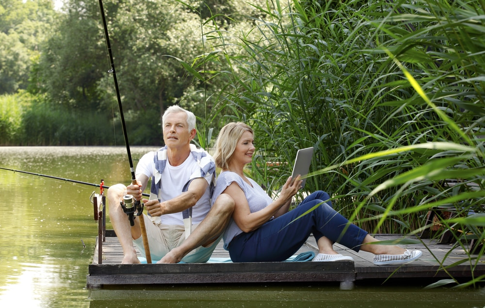 How to enjoy this summer without watching the World Cup: Couple fishing by lake