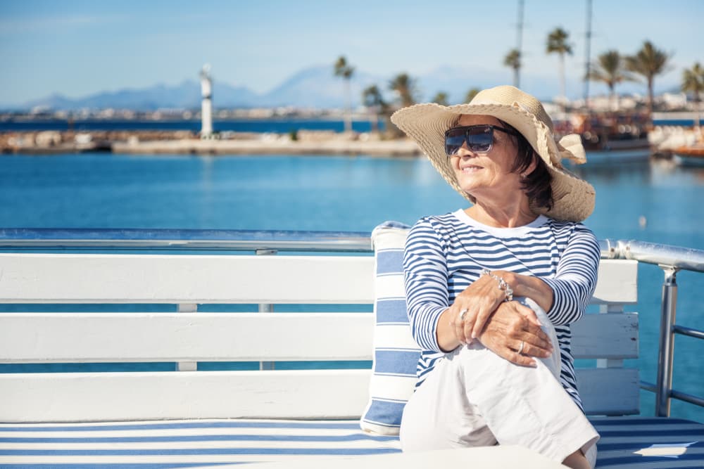 Over 60 Singles Holiday Ideas & Inspiration: Senior woman on holiday by the sea