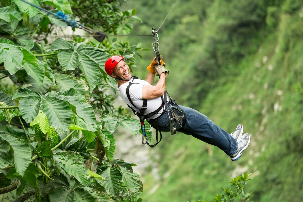 The 5 best ecotourism holidays for mature travellers: Mature man on zip wire