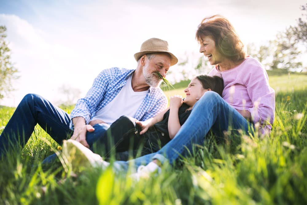 How to be a holiday eco-hero | Environmentally friendly trips: grandparents playing outdoors with child