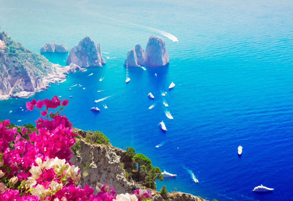 Top 5 travel destinations for spring 2019: Faraglioni cliffs and Tyrrhenian Sea, Capri island, Italy