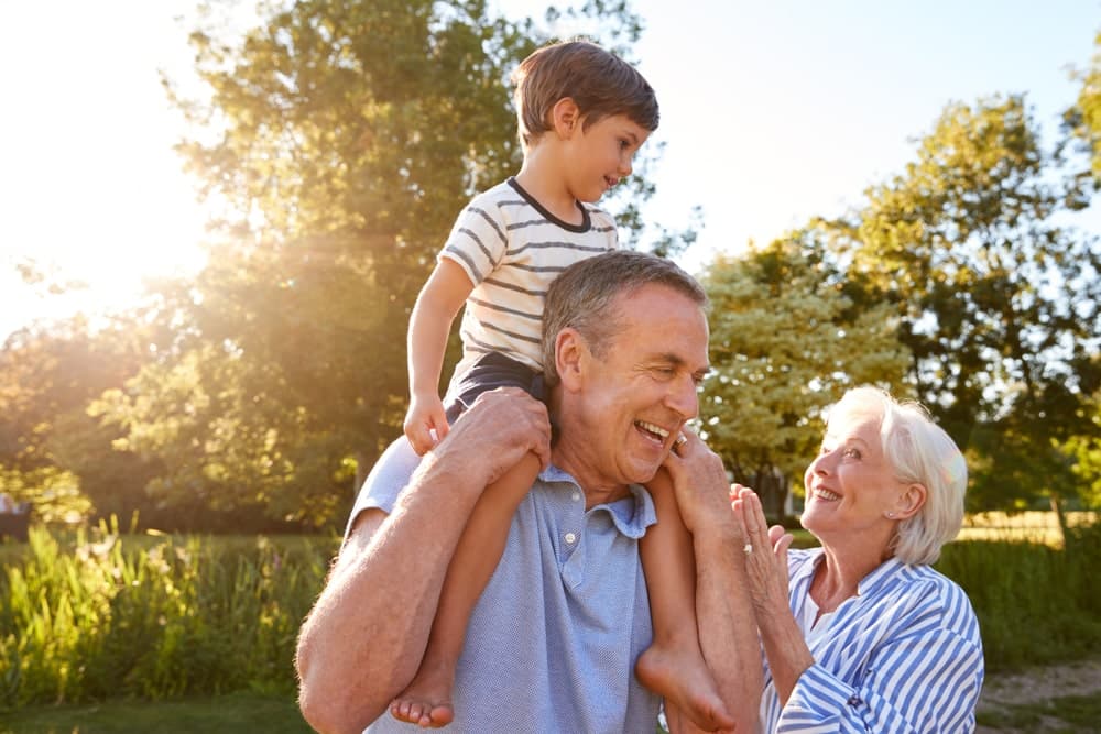 New Group to Support Access to Travel Insurance for Vulnerable Customers: grandparents on holiday with child playing in forest