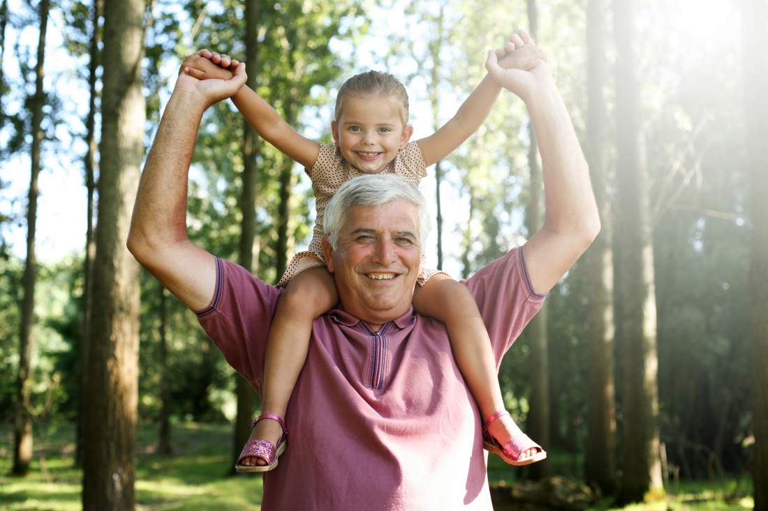 Grandfather Proving his Worth in Half-Term Childcare carrying grandaughter on his shoulders