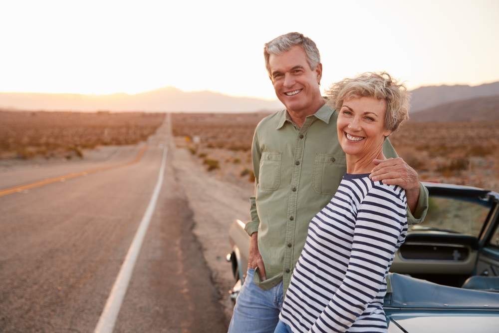 A Guide to Insurance When Airlines or Travel Companies Go Bust: Middle aged happy couple on route 66