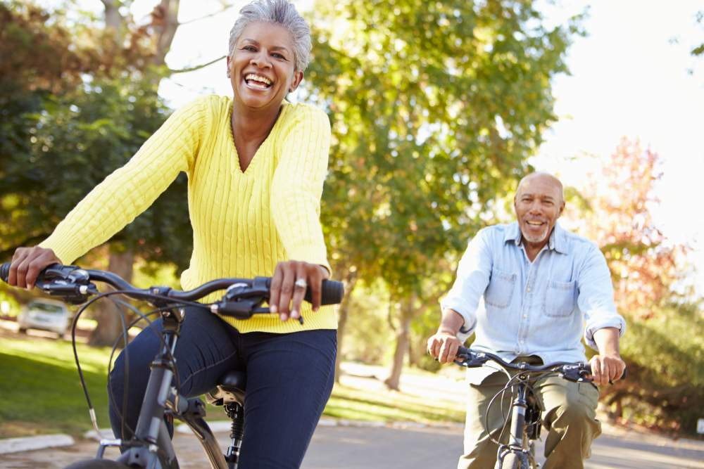 Know your numbers week 2019: Mature couple cycling in park