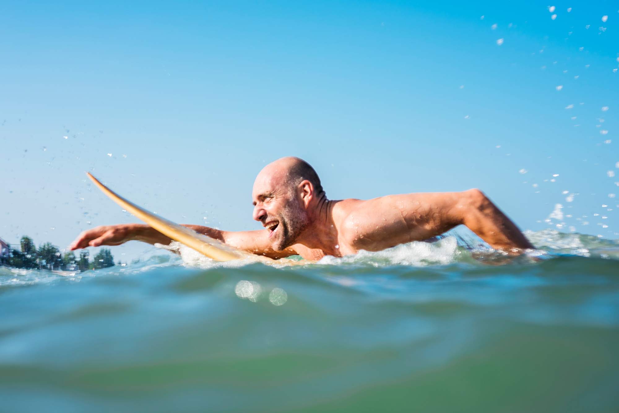 Middle aged man swimming in the ocean as New Research Reveals the Truth About Ageing