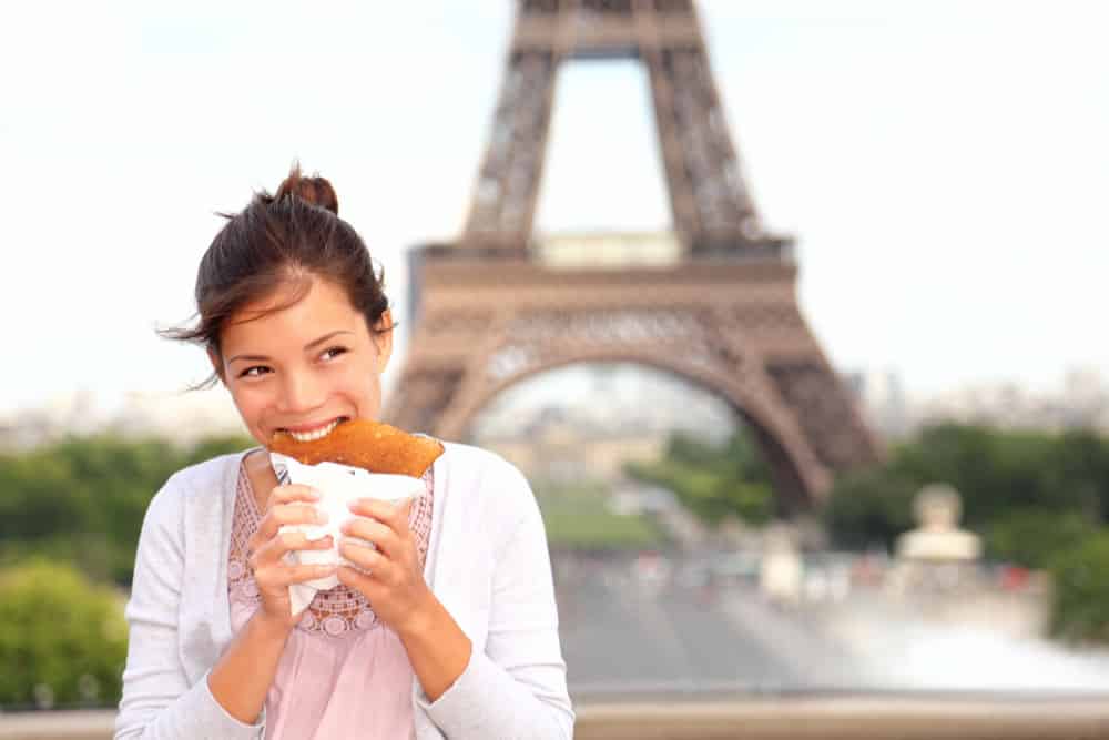 woman enjoying a pancake in Paris