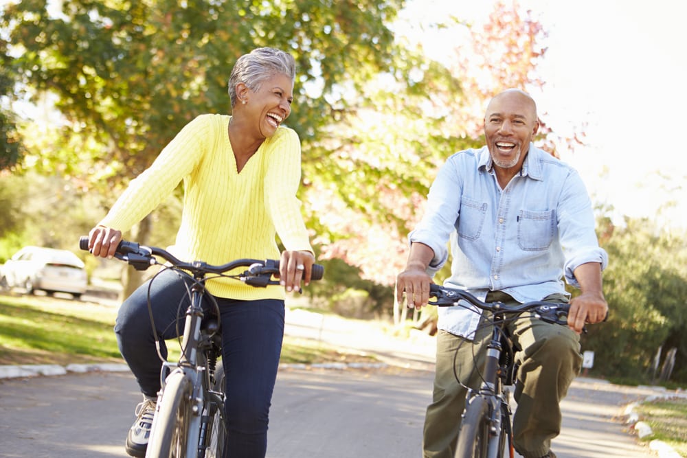 Travelling with a mental health condition: Mature couple cycling in park