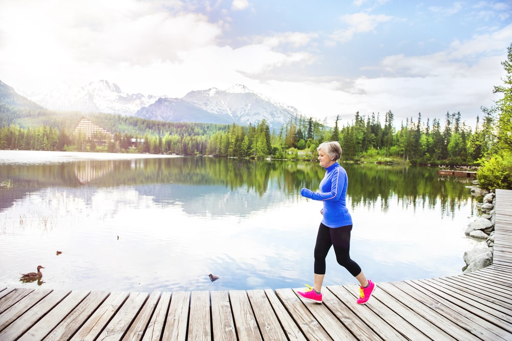 How to enjoy this summer without watching the World Cup: Old woman running by lake