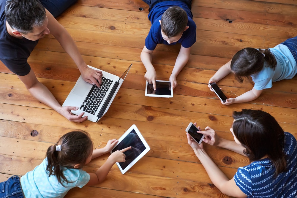 Do I Need Travel Insurance? Is It Worth It? Family playing on iPads and computers